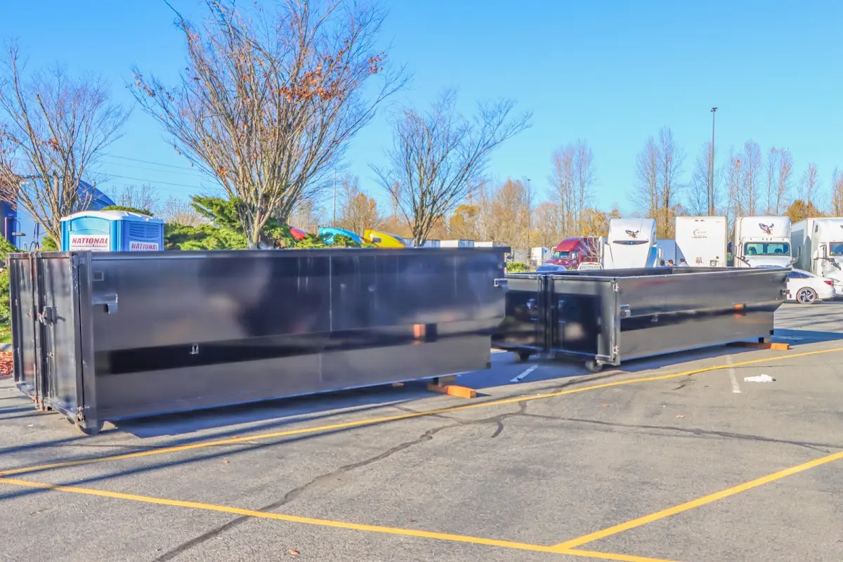 Professional dumpster rental service with roll-off container on residential driveway in Prunedale